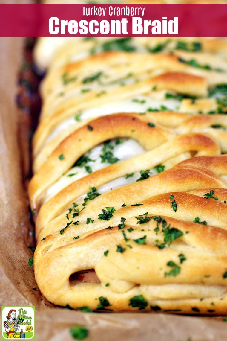 Closeup of a Turkey Cranberry Crescent Braid on a piece of brown parchment paper.