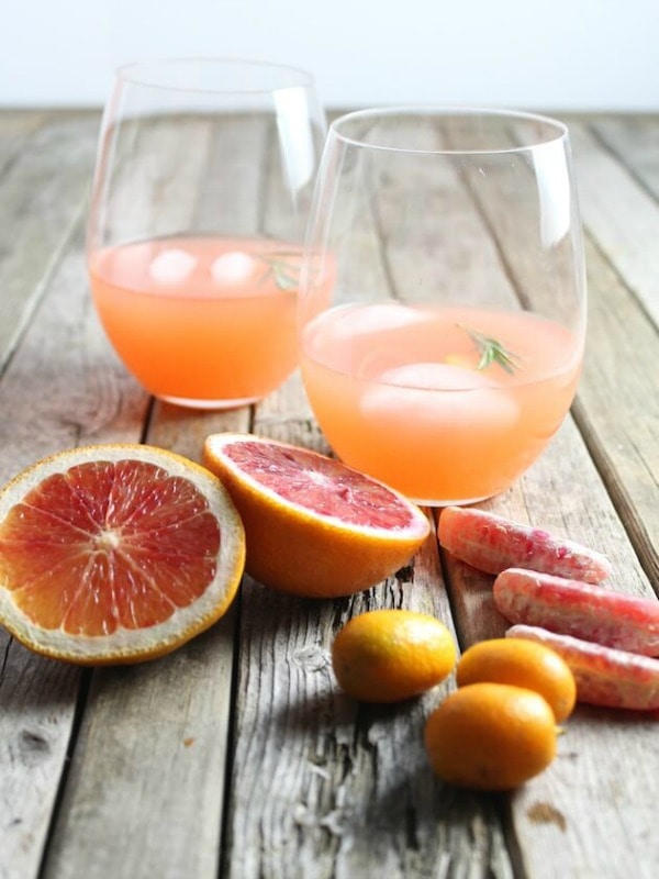 Glasses of Aperol Punch with sliced grapefruit.