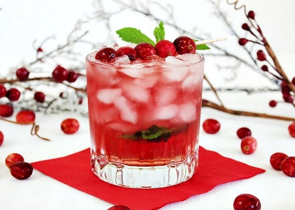 A glass of Cranberry Ginger Fizz Cocktail on a red napkin.