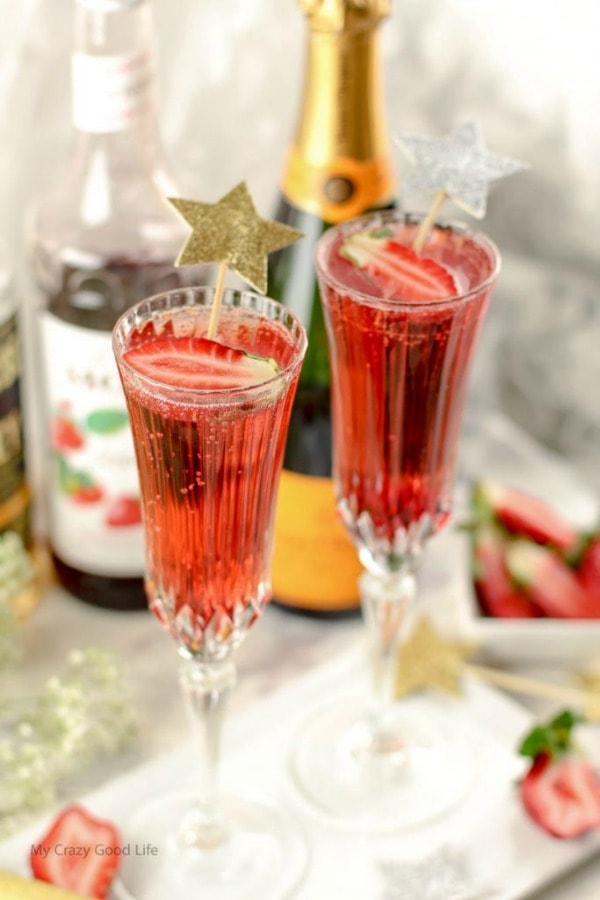 Flutes of Champagne Cocktails with strawberries.