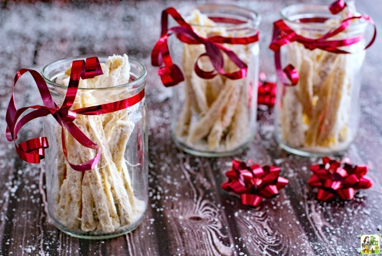 Glass jars of Candied Ginger with red ribbon.