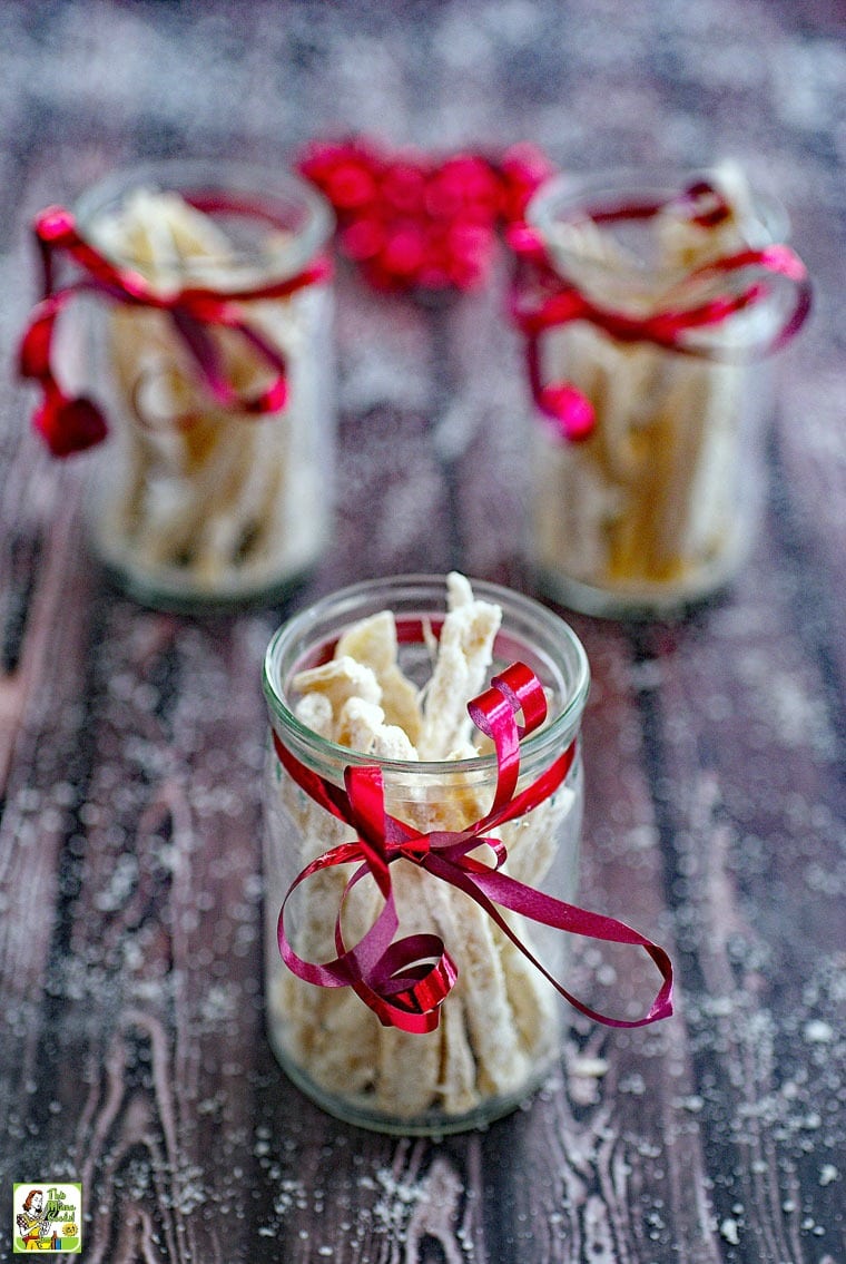 Glass jars of candied ginger wrapped in red ribbon.