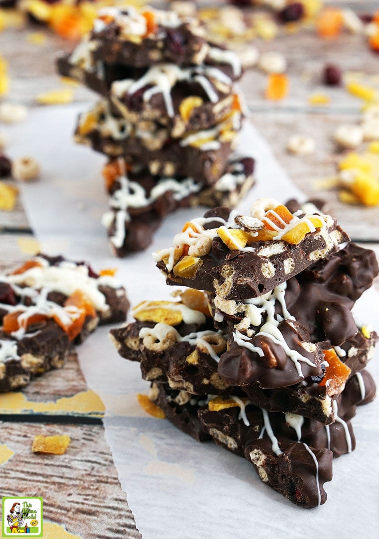Stacks of chocolate bark candy on white parchment paper.