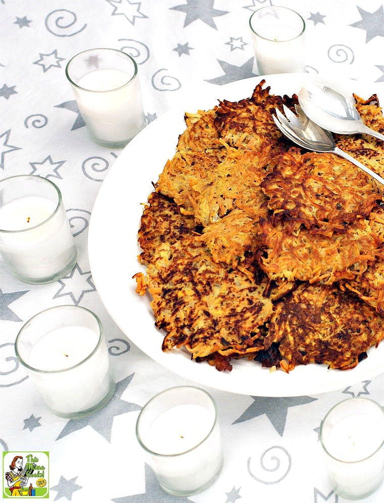 A platter of Sweet Potato Pancakes with candles and serving spoon and fork.