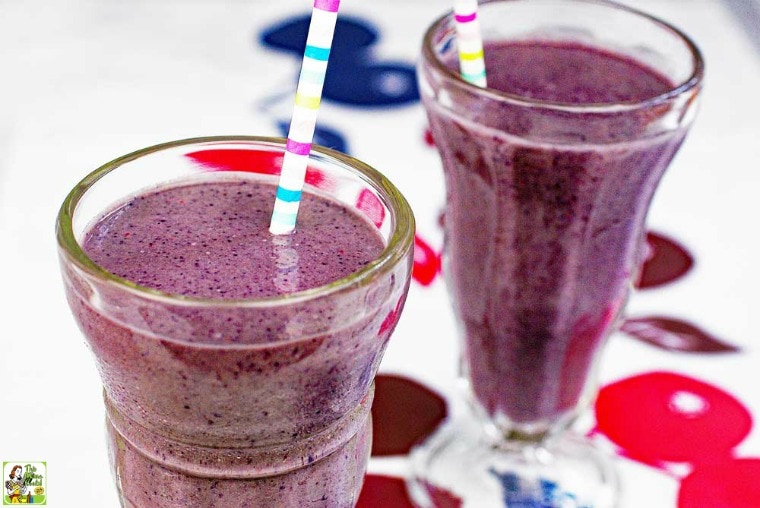Berry Smoothies in tall glasses with straws.