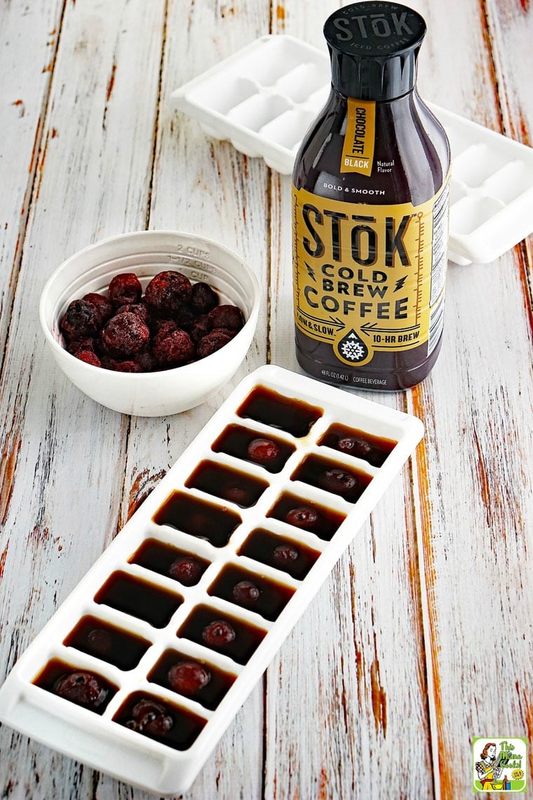 Bowl of frozen cherries and cold brew coffee to make fruit filled cold brew ice cubes.