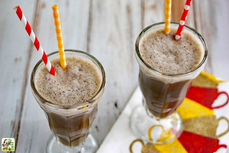Two Coffee Smoothies in tall glasses with straws.