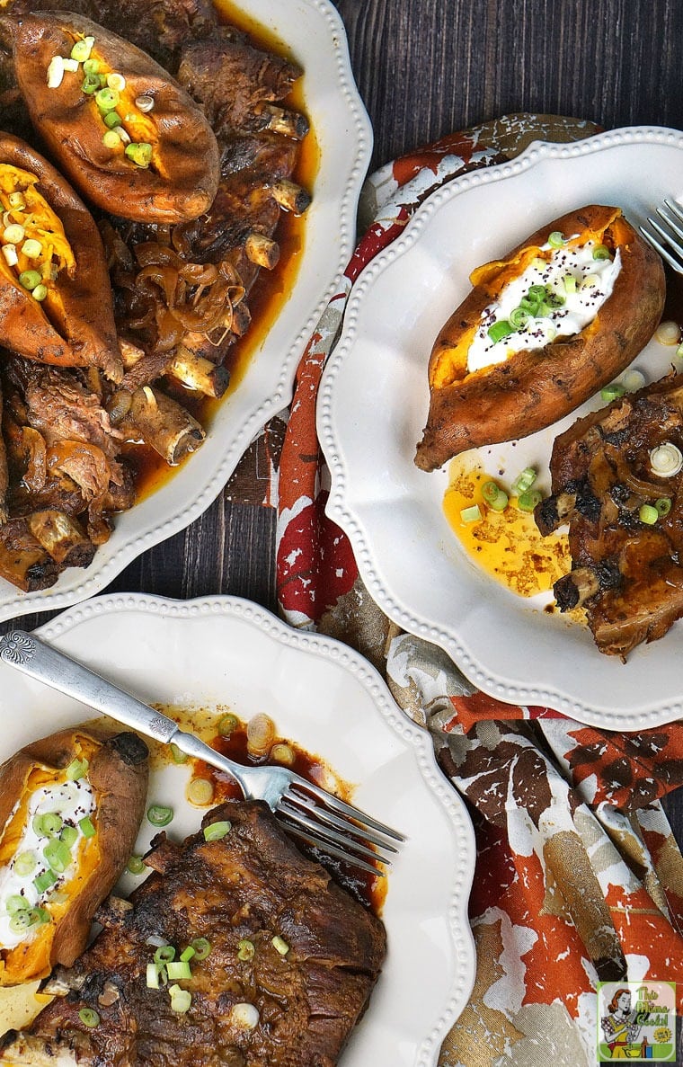 Overhead shot of plates and platters of Crock-Pot Ribs and sweet potatoes