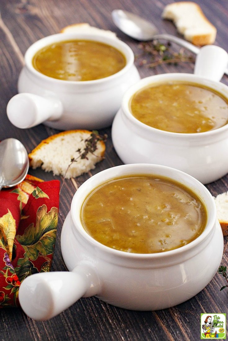 Three bowls of split pea soup with bread, sprigs of thyme, spoons, and red napkins.