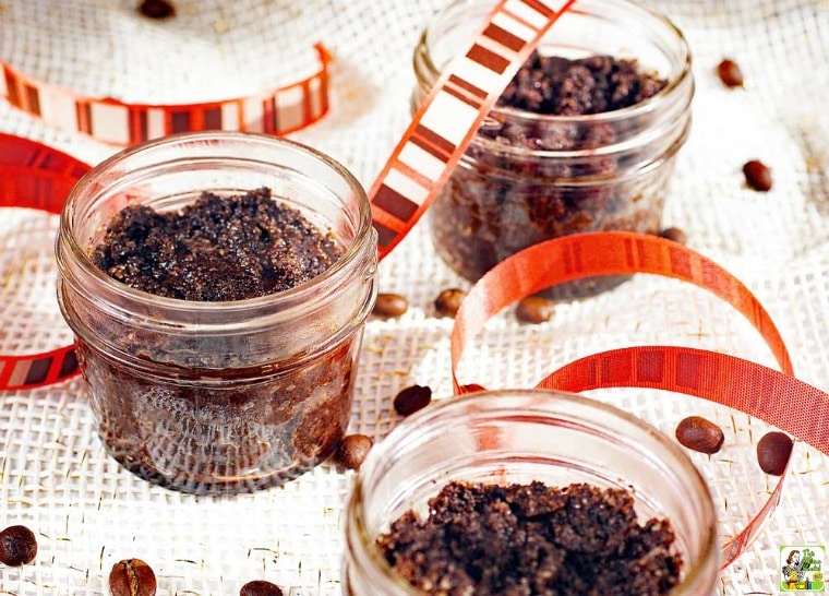 DIY coffee scrub in small glass jars with orange, white and brown striped ribbons.