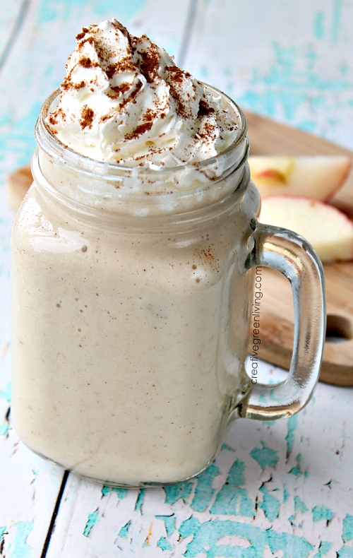 A glass mug of Gluten Free Apple Pie Smoothie with whipped cream.