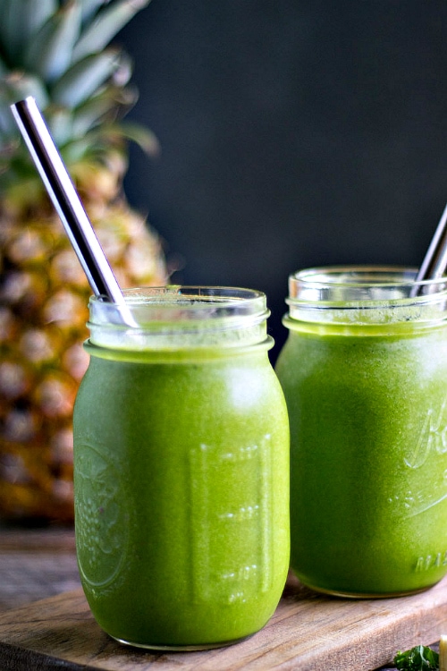 Mason jars of Green Powerhouse Summer Smoothie with straws.