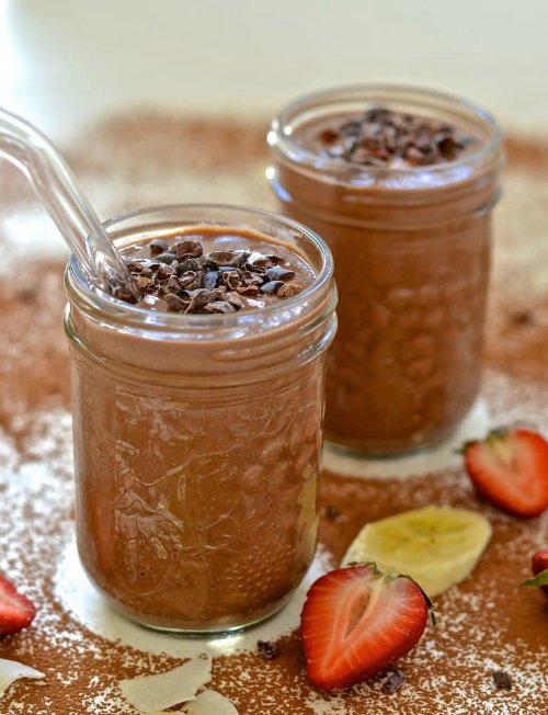 Jars of Healthy Chocolate Smoothie with fruit slices.