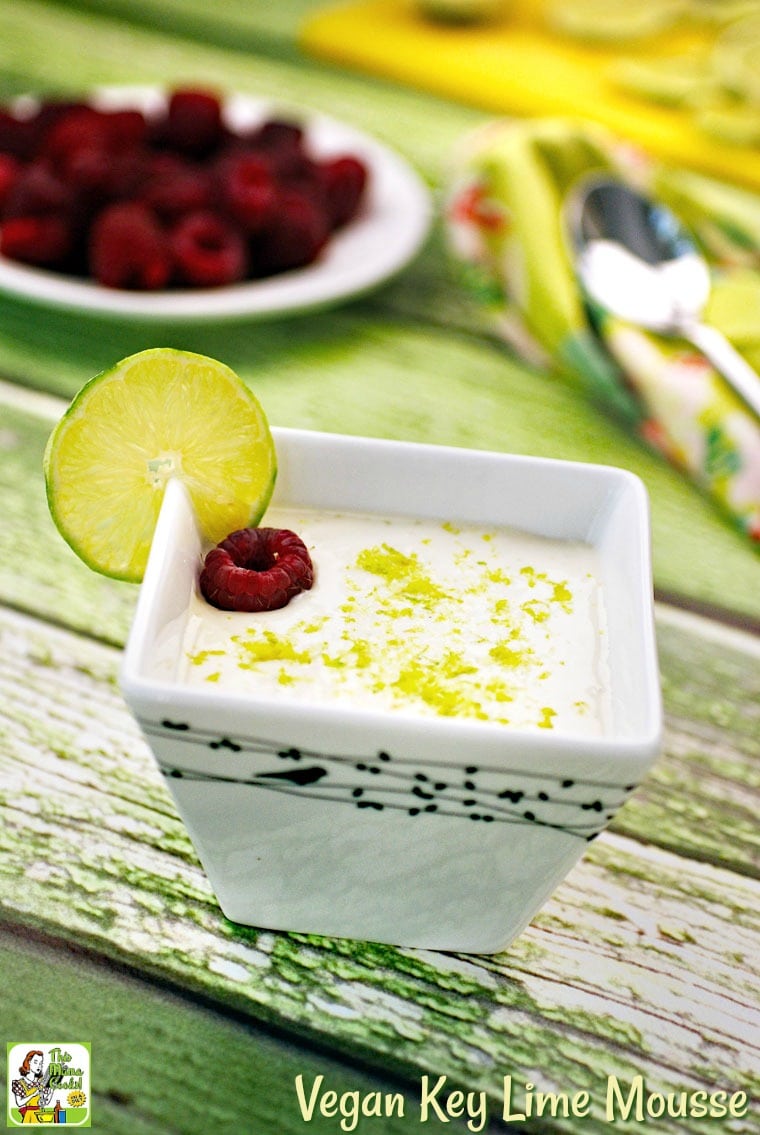 A bowl of Key Lime Mousse garnished with a slice of lime and a raspberry.