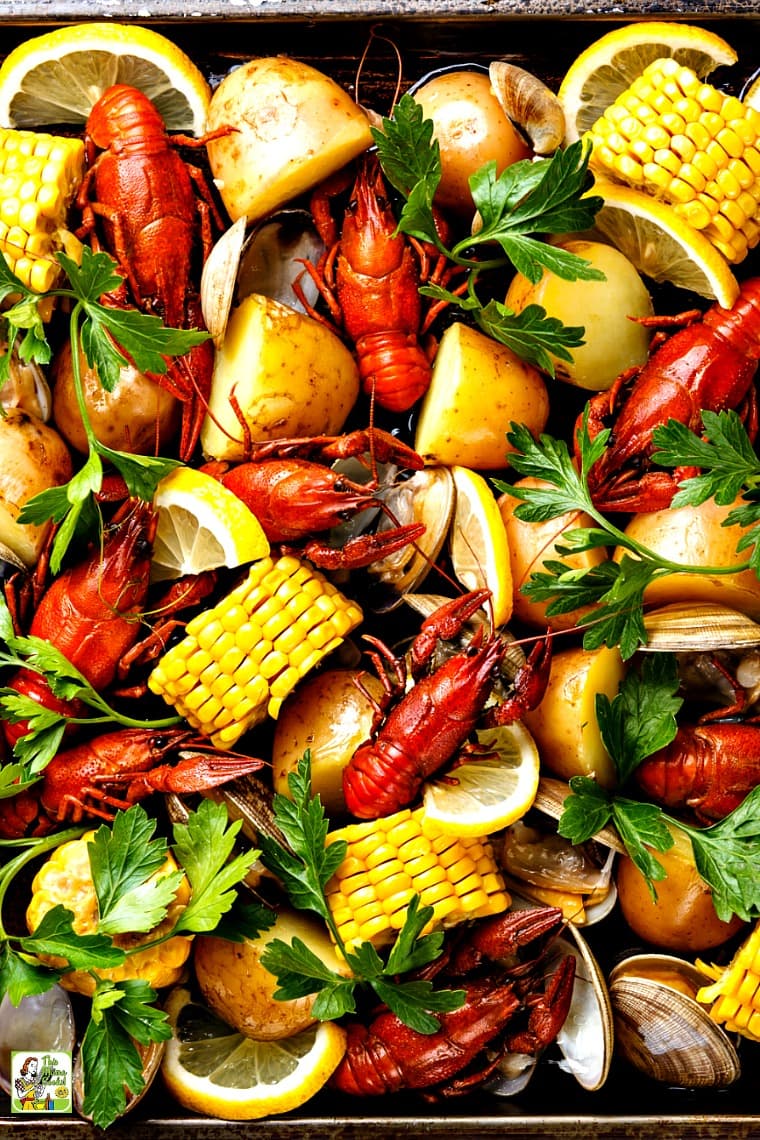 A Cajun seafood boil with boiled crawfish, corn on the cob, potatoes, and clams.
