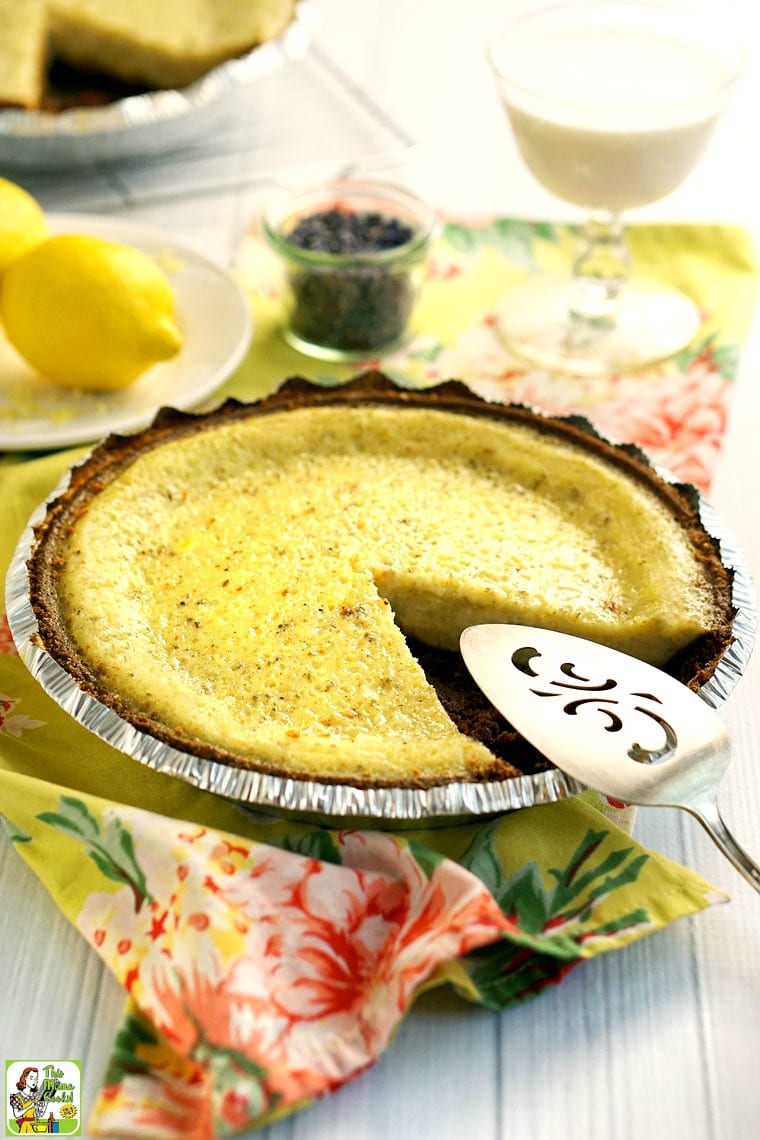 A buttermilk pie with a slice missing and a serving knife.
