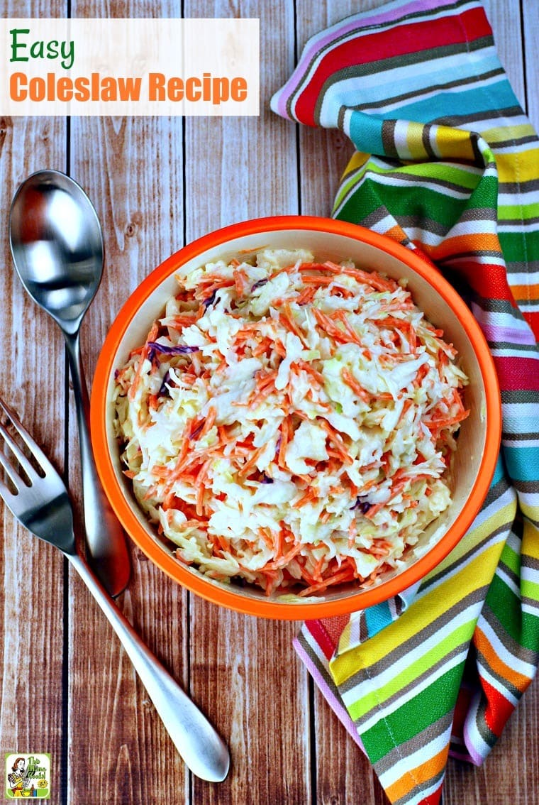 Overhead view of An orange bowl of Easy Coleslaw with striped kitchen towel and serving fork and spoon.