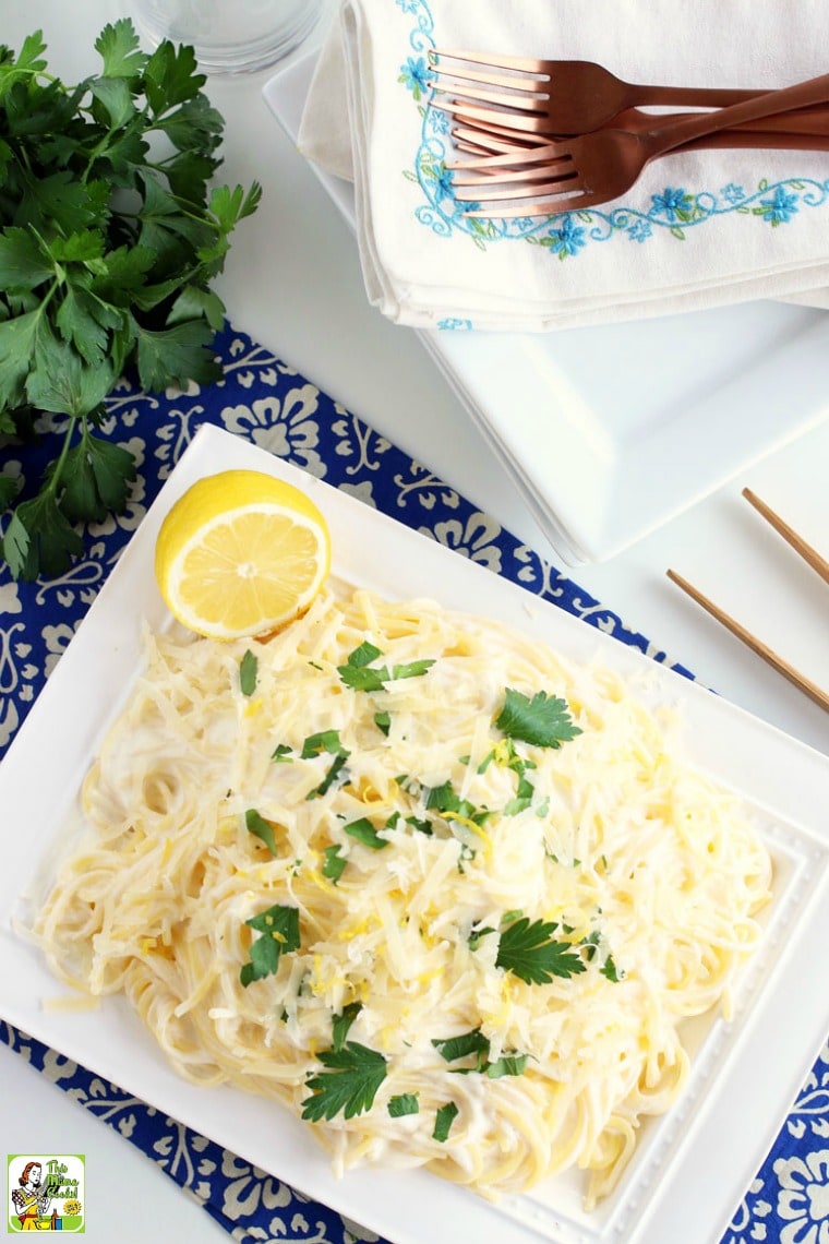 Overhead of a dish of lemon pasta with lemon zest, cheese and parsley.