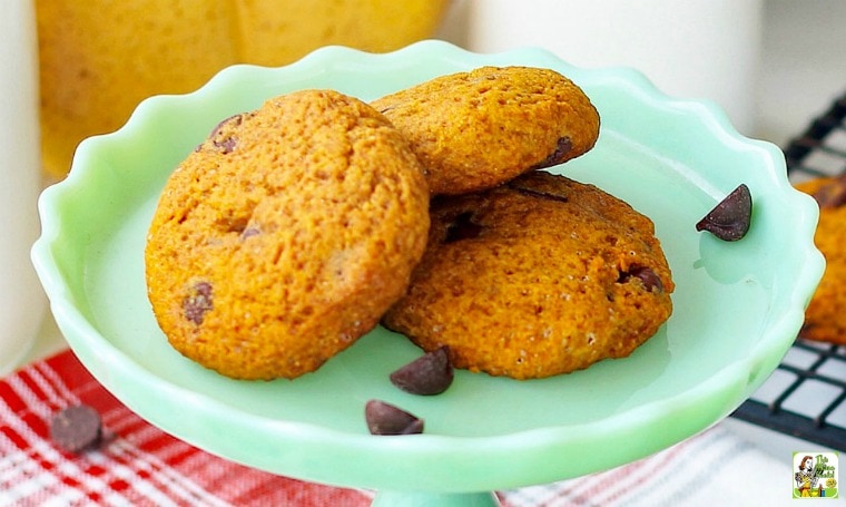 A green cake stand with chocolate chip pumpkin cookies.