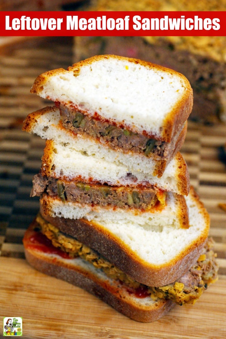 Closeup of a stack of meatloaf sandwiches on a wooden cutting board.