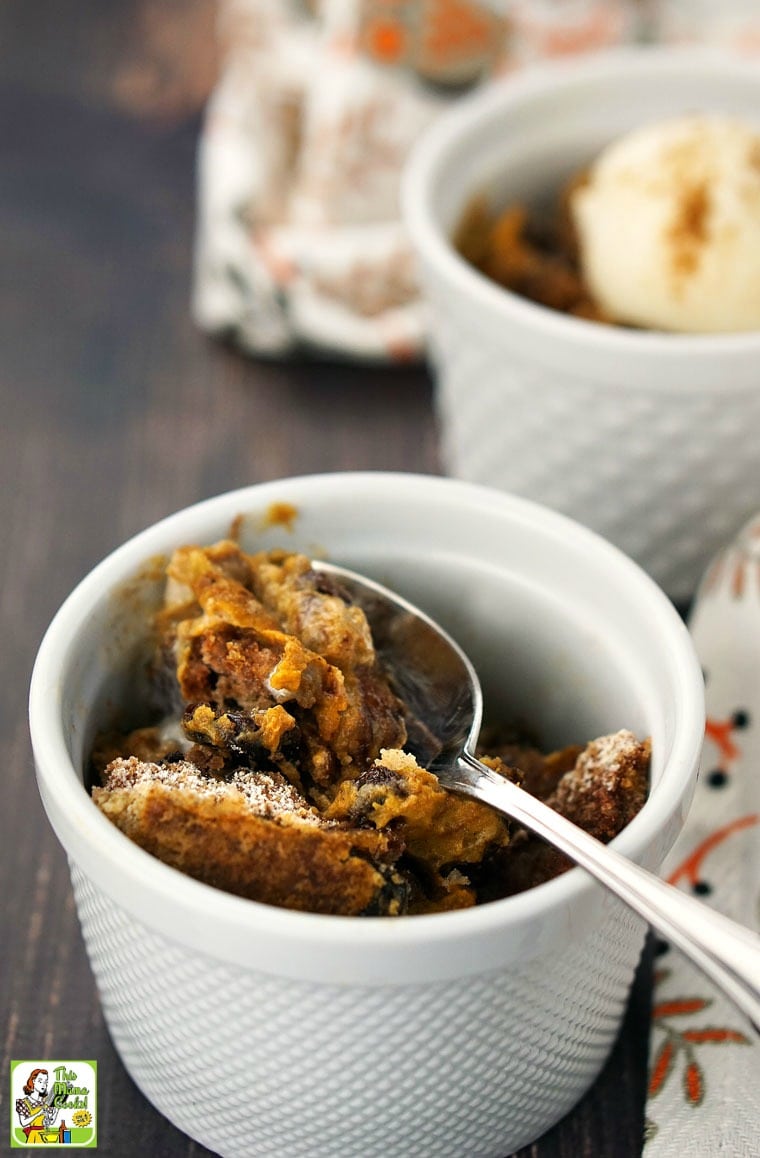 A bowl of pumpkin dump cake with a spoon.