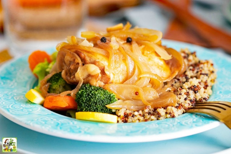 A blue plate of Slow Cooker Chicken Adobo with Quinoa and vegetables.