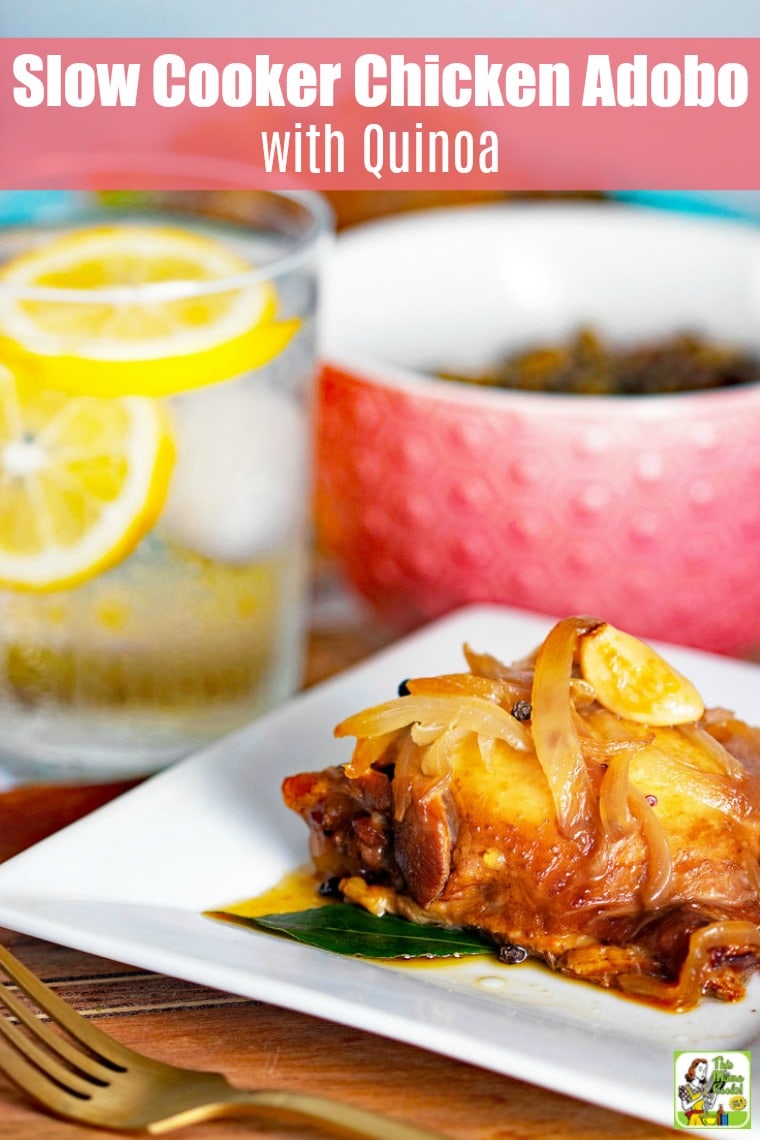 Closeup of slow cooker chicken adobo on a white plate with a gold fork.