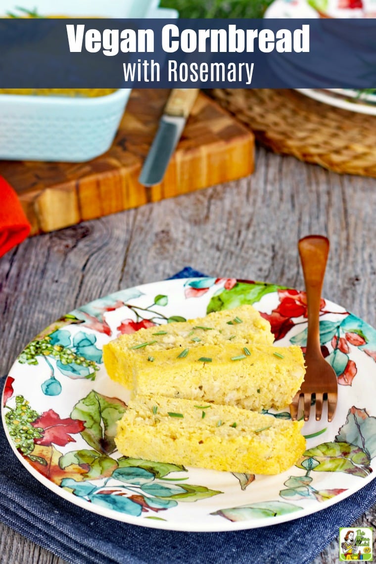 A slice of vegan cornbread on a colorful plate with a copper fork.