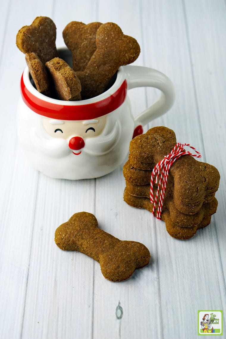 Dog treats in a Santa mug and wrapped in red string.