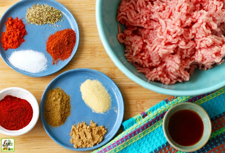 Dishes of spices, ingredients and ground meat to make homemade chorizo sausage.