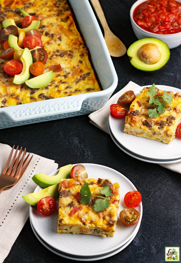 Plates of Overnight Breakfast Casserole with avocados and tomatoes.