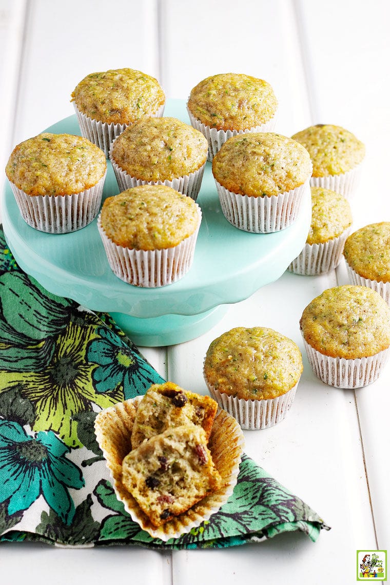 Zucchini Muffins on a cake stand with a colorful floral napkin