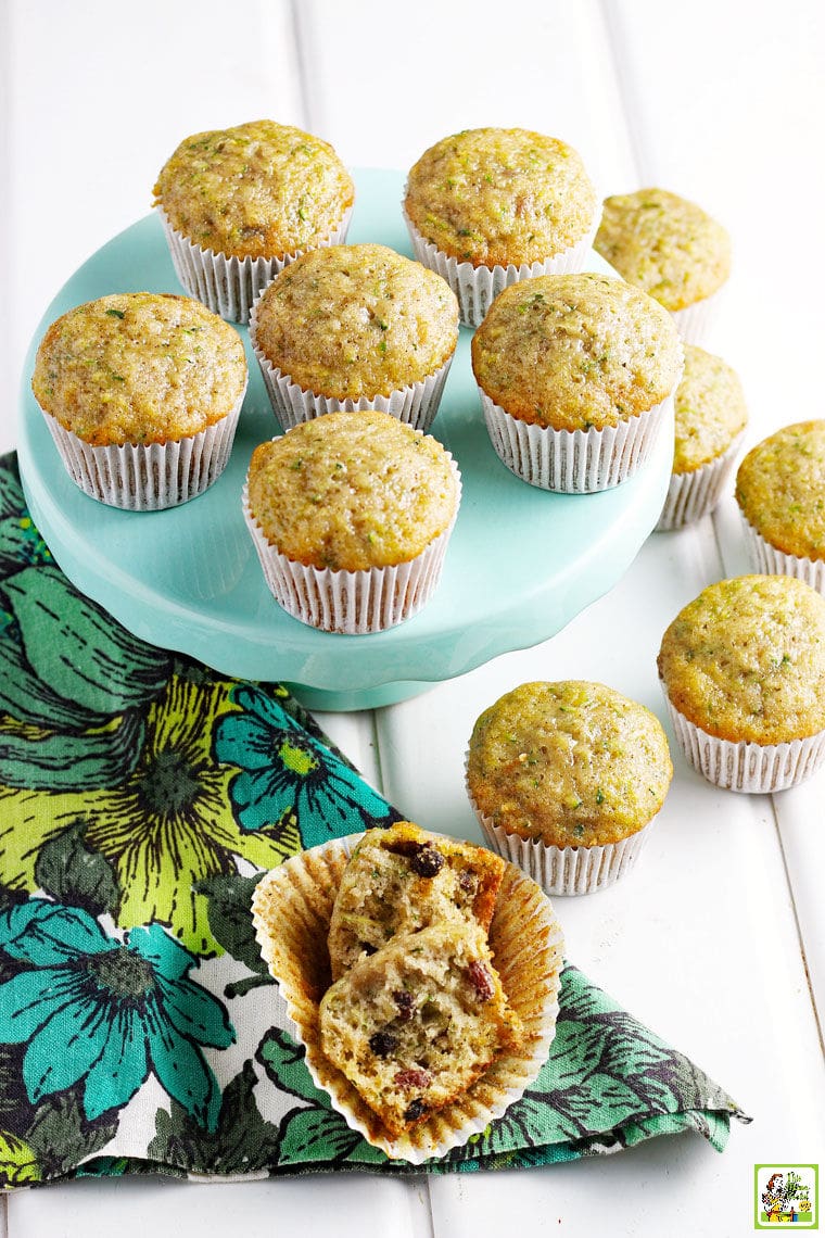 Dozens of muffins on and around a light teal green cake stand