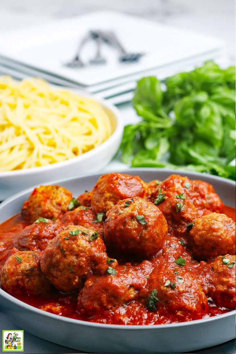 A bowl of cooked turkey meatballs in sauce with pasta.