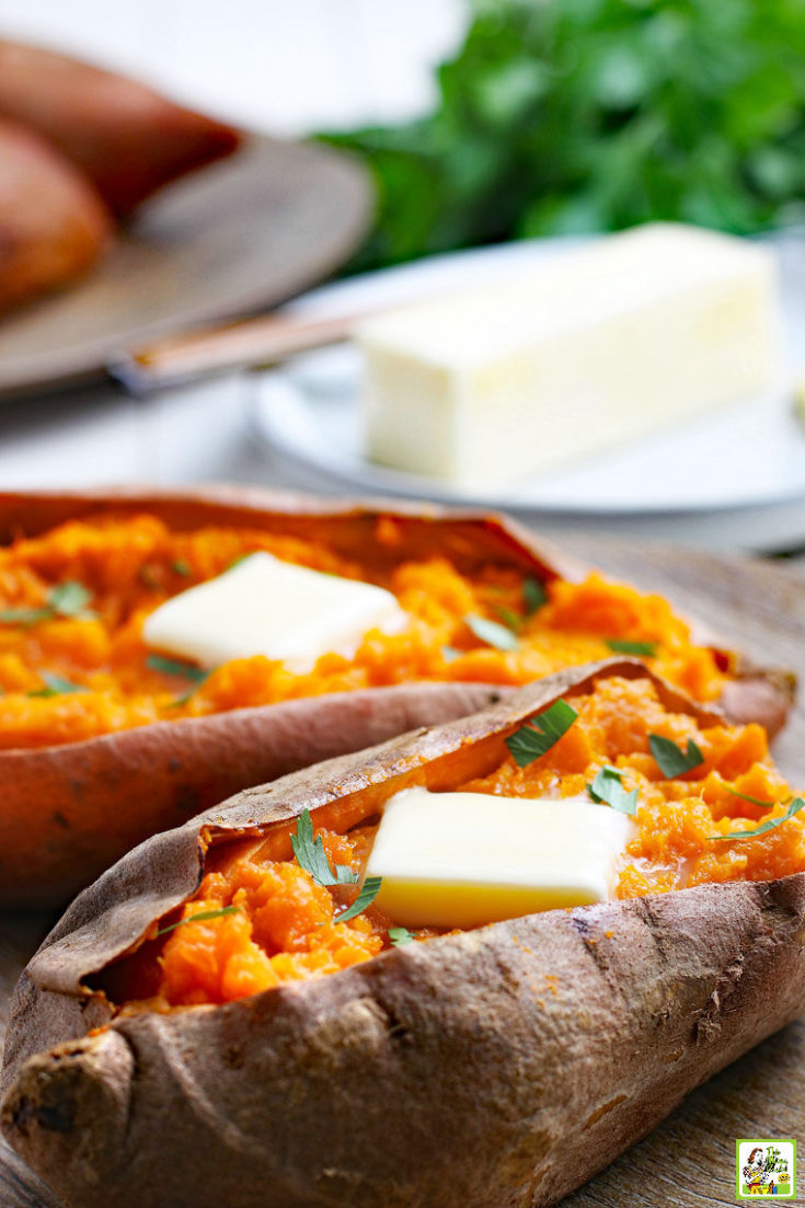 Cooked sweet potatoes with pats of butter and a stick of butter in the background.