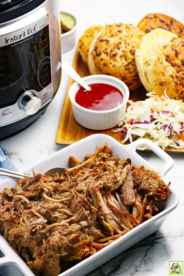 A platter of pulled pork, BBQ sandwich fixings, and an Instant Pot.