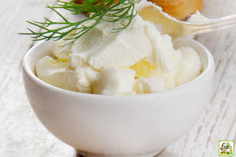 Small white bowl of softened cream cheese.