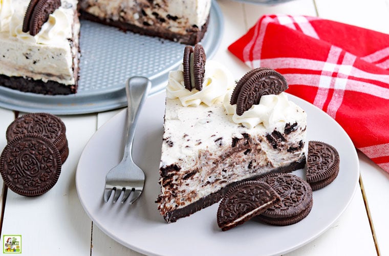 A plate of no bake Oreo cheesecake with a fork and a red napkin.