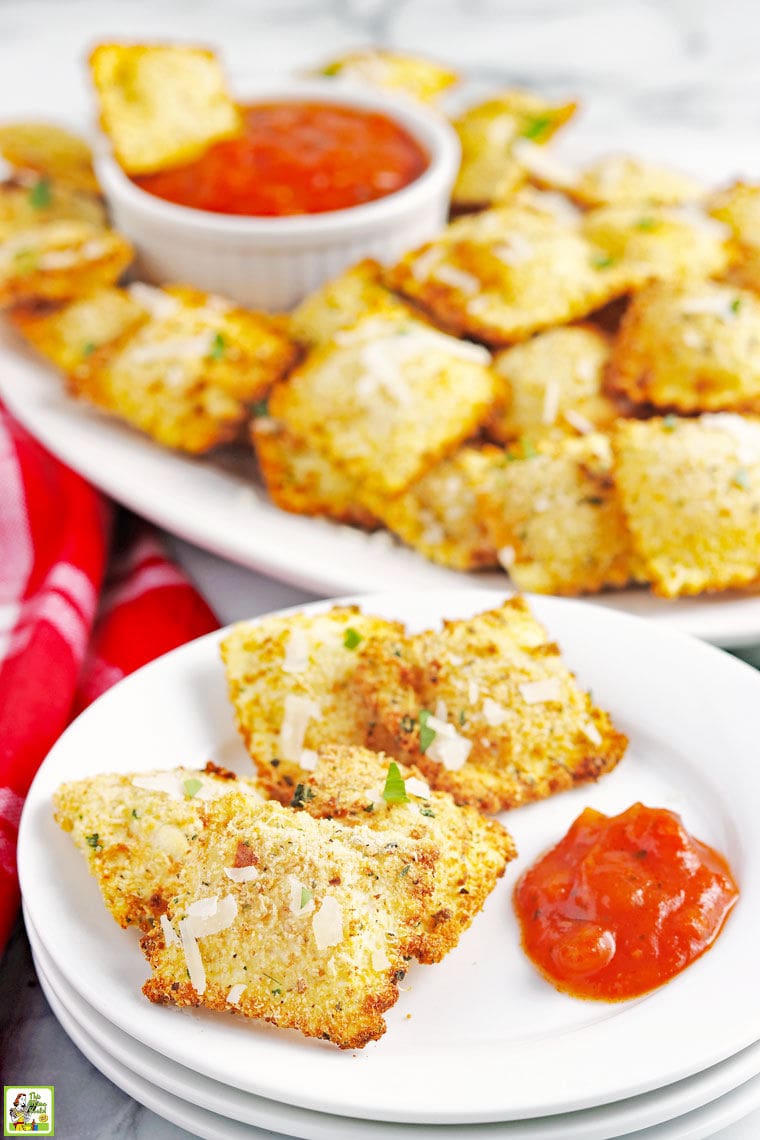 A plate and platter of air fryer ravioli appetizers with red cloth napkin.
