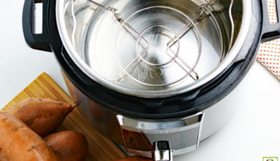 Empty Instant Pot with trivet and sweet potatoes.