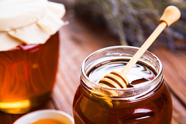 Jars of honey with honey dipper.