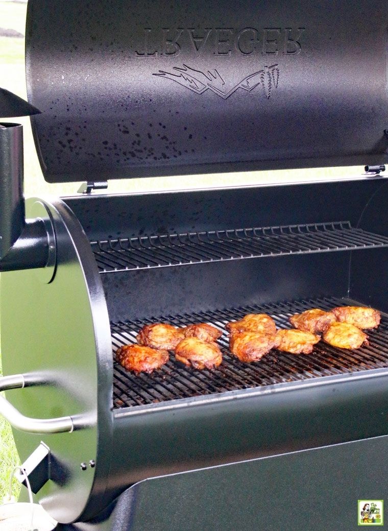 Chicken cooking on a Traeger smoker pellet grill.