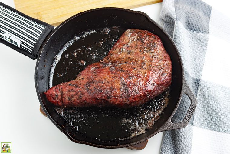 Doing a reverse sear on a smoked tri-tip beef roast in a cast iron skillet.